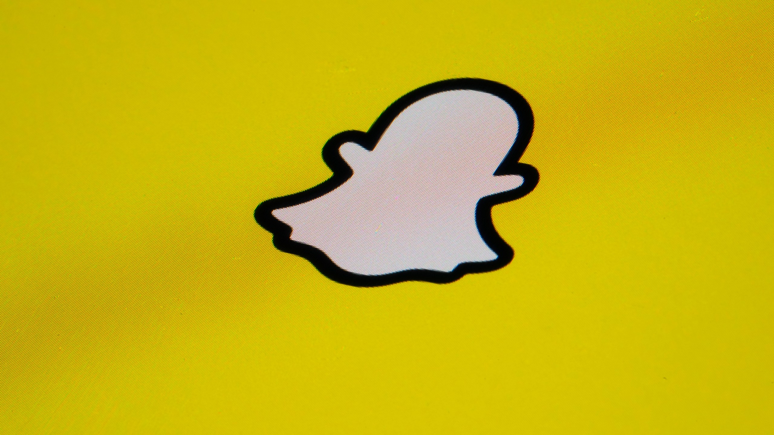 FILE - The icon for instant messaging app Snapchat is seen on a smartphone, Tuesday, Feb. 28, 2023, in Marple Township, Pa. The owner of Snapchat will pay $15 million to settle a lawsuit brought by California's civil rights agency that claimed the company discriminated against female employees, failed to prevent workplace sexual harassment and retaliated against women who complained. (AP Photo/Matt Slocum)