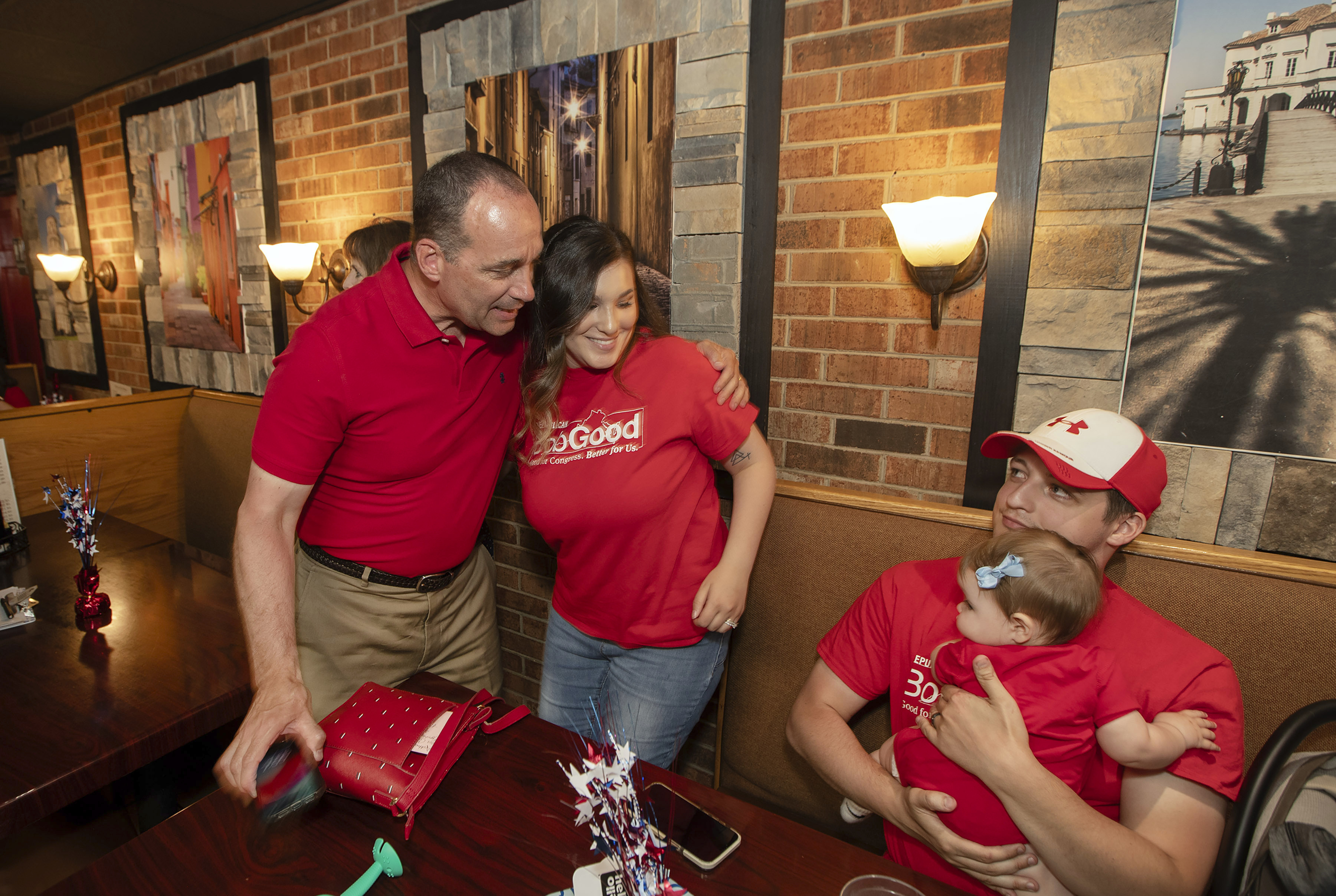 FILE - Rep. Bob Good, left, a candidate in the Republican primary for the state's 5th Congressional District, greets family members at a watch party in Lynchburg, Va.,, June 18, 2024. On Monday, June 24, 2024, The Associated Press said the race between Good and Sen. John McGuire was still too close to call. (AP Photo/P. Kevin Morley, File)