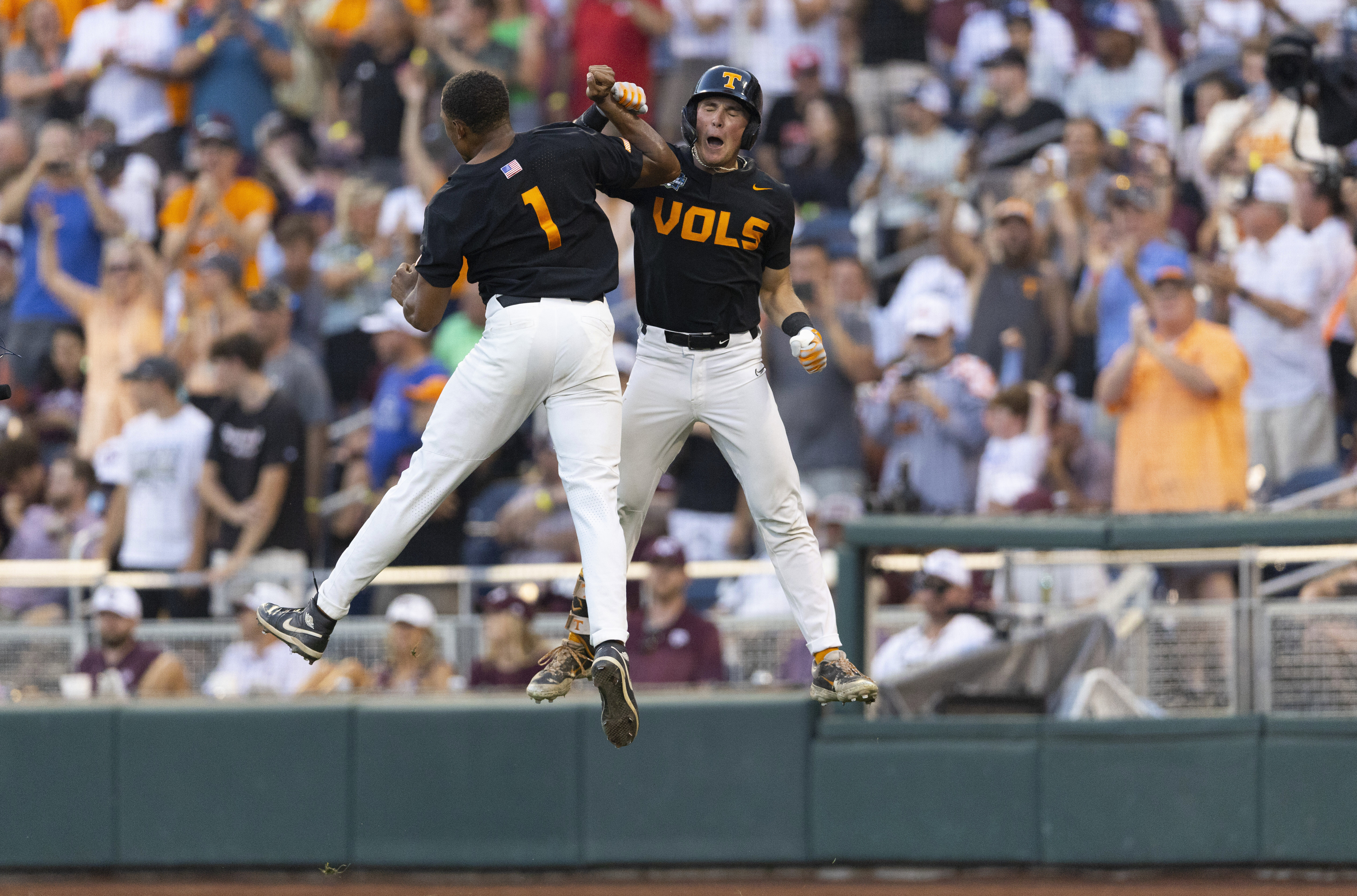 Tennessee's Christian Moore, left, celebrates with Dylan Dreiling after Dreiling hit a two-run home run against Texas A&M in the seventh inning of Game 3 of the NCAA College World Series baseball finals in Omaha, Neb., Monday, June 24, 2024. (AP Photo/Rebecca S. Gratz)